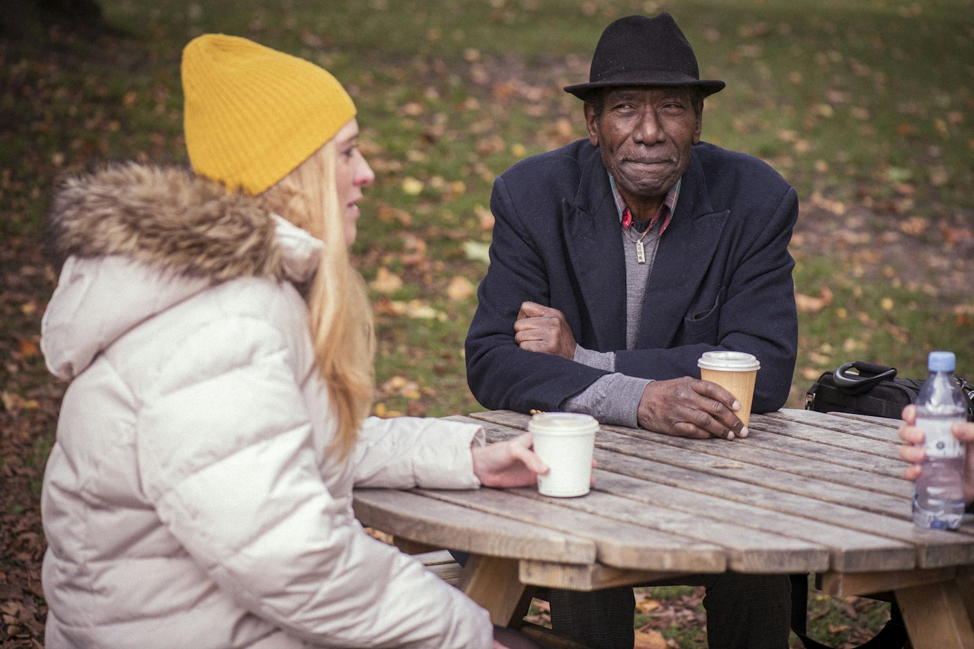A man and a woman sitting at a picnic table