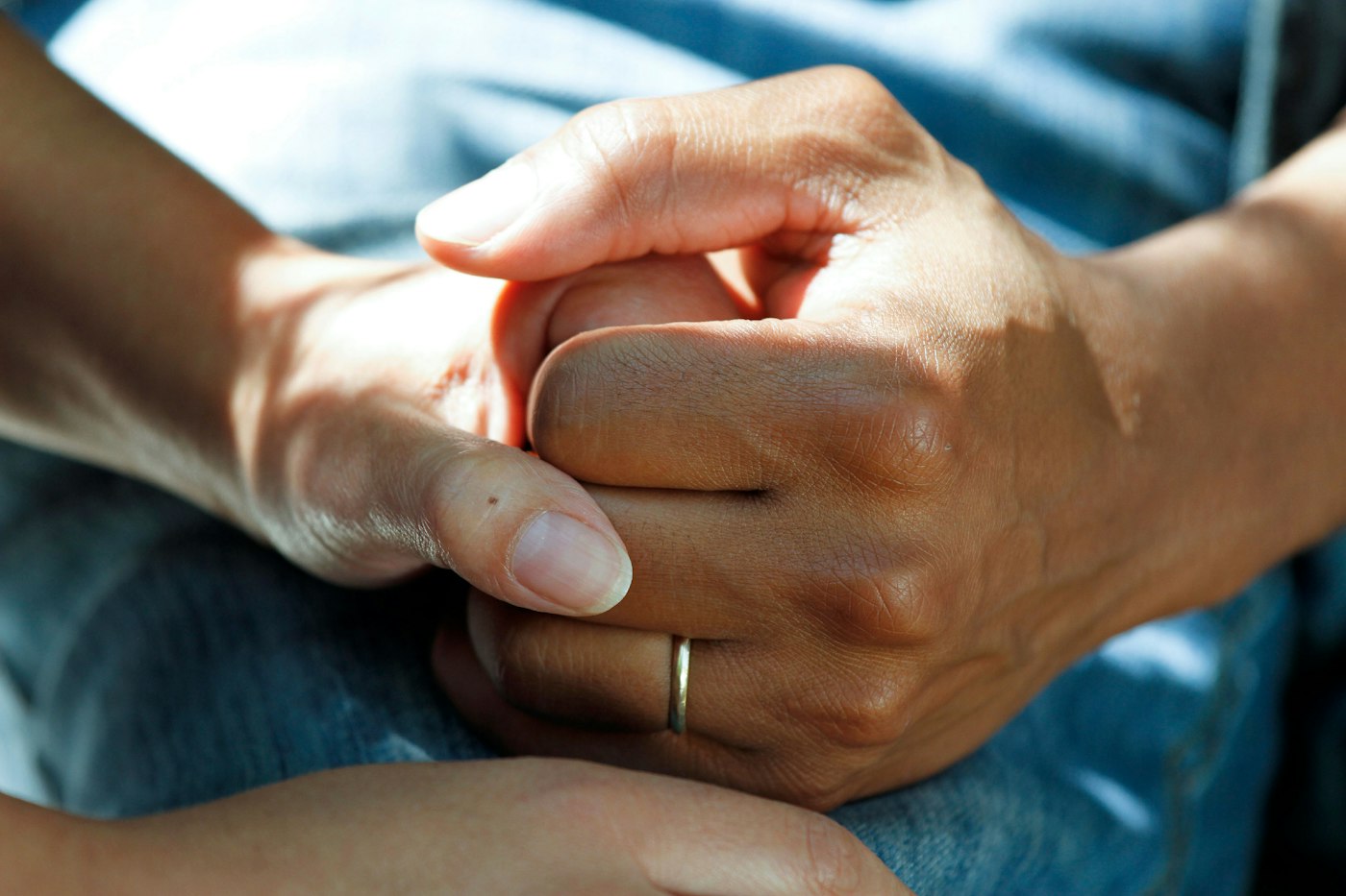 Person wearing gold wedding band